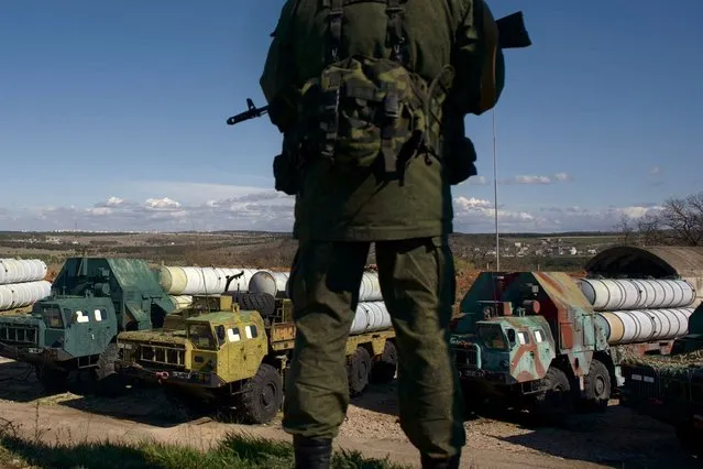 Russian soldier guards a Soviet-made anti-aircraft missile launchers at a Ukrainian military unit, in Sevastopol, Ukraine, on Wednesday, March 5, 2014. Ukraine's new prime minister said Wednesday that embattled Crimea must remain part of Ukraine, but may be granted more local powers. Since last weekend, Russian troops have taken control of much of the peninsula in the Black Sea, where Russian speakers are in the majority. (Photo by Andrew Lubimov/AP Photo)