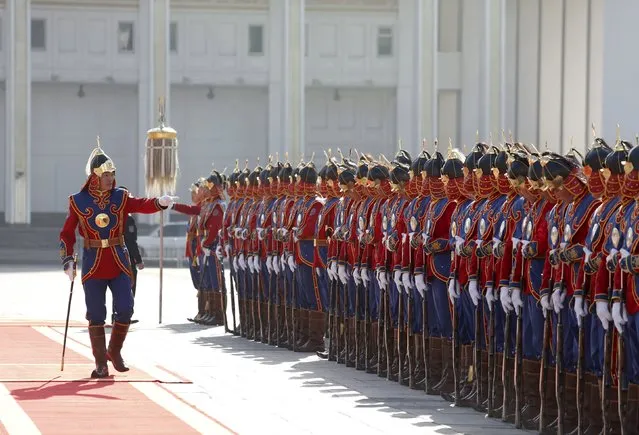 Commander (L) of an honour guards gestures as he prepares his troops before a welcoming ceremony for the visiting Bulgarian President Rosen Plevneliev (not pictured) outside the national parliament building at Sukhbaatar square, in Ulan Bator, Mongolia, May 11, 2015. (Photo by B. Rentsendorj/Reuters)