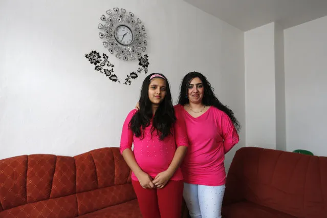 Bulgarian migrant Ayshe Kakarmustafa, 33, and her daughter Neriman, 11, pose for a photograph at their home in Dortmund, Germany February 22, 2014. Ayshe finished school at 14 and used to work in a shoe factory in Bulgaria. When she was a girl, she wanted to become a hairdresser. Ayshe hopes that her daughter Neriman will do whatever she wants when she grows up. Neriman would like to become a doctor. (Photo by Ina Fassbender/Reuters)