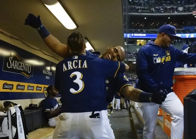 Milwaukee Brewers' Jesus Aguilar celebrates his three-run home run with Orlando Arcia (3) during the first inning of a baseball game against the Colorado Rockies Monday, April 29, 2019, in Milwaukee. (Photo by Morry Gash/AP Photo)