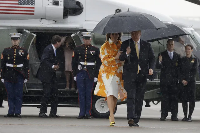 President Donald Trump and first lady Melania Trump walk to board Air Force One as they depart Haneda International Airport Tuesday May 28, 2019, in Tokyo. (Photo by Evan Vucci/AP Photo)