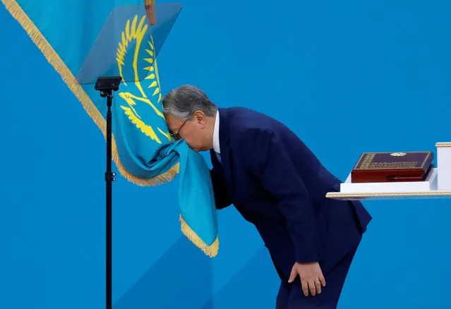 Kazakhstan's President Kassym-Jomart Tokayev kisses the state flag during his inauguration ceremony in Nur-Sultan, Kazakhstan on June 12, 2019. (Photo by Mukhtar Kholdorbekov/Reuters)