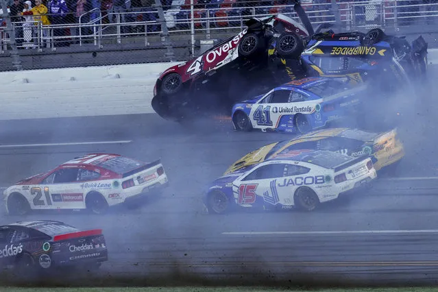 NASCAR Cup Series driver's Ryan Preece (41) Josh Berry (4) and Corey LaJoie (7), upside down, crash on the final lap during a NASCAR Cup Series auto race at Talladega Superspeedway, Sunday, April 21, 2024, in Talladega. Ala. (Photo by Butch Dill/AP Photo)
