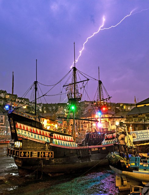 A bolt of lightning stikes over the Golden Hind ship in Brixham Harbour, United Kingdom on September 17, 2023. (Photo by Chris Slack/Animal News Agency)