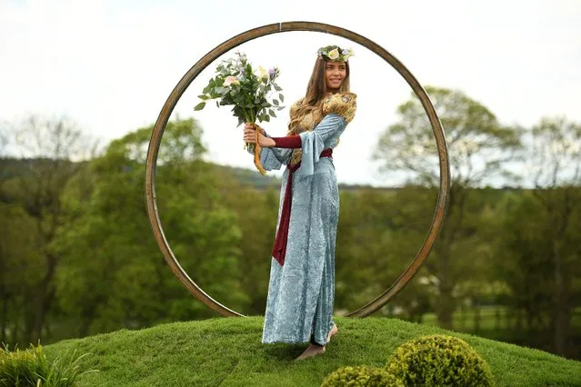 Model Freya Lee, dressed as the Lady of Shalott, poses for a photograph in the “Escape your mind” show garden during a photocall to promote the Harrogate Spring Flower Show at the Great Yorkshire Showground in Harrogate, northern England on May 19, 2021. (Photo by Oli Scarff/AFP Photo)