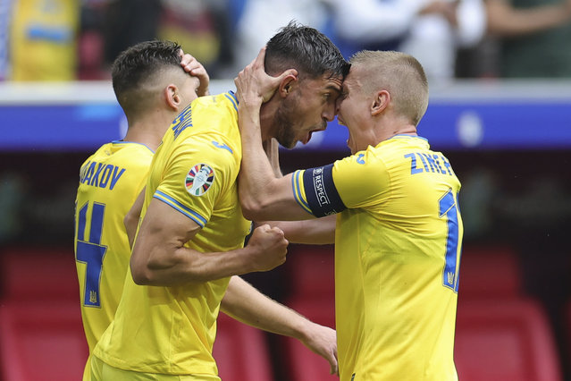Ukraine's Roman Yaremchuk, center, celebrates after scoring his side's second goal during a Group E match between Slovakia and Ukraine at the Euro 2024 soccer tournament in Duesseldorf, Germany, Friday, June 21, 2024. (Photo by Rolf Vennenbernd/dpa via AP Photo)
