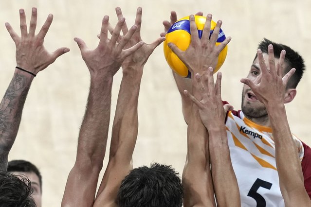 Moritz Reichert, of Germany, is blocked by players from USA during their Volleyball Men's Nations League match at the Mall of Asia Arena in Manila, Philippines on Saturday, June 22, 2024. (Photo by Aaron Favila/AP Photo)