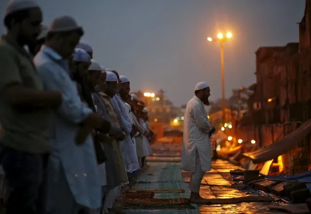 Muslims offer prayers after having their Iftar (breaking of fast) meal during the holy month of Ramadan in the old quarters of Delhi, India, July 10, 2015. (Photo by Anindito Mukherjee/Reuters)