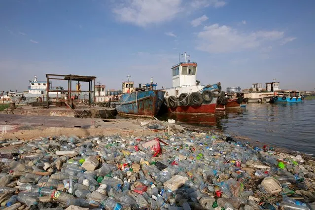 Plastic waste pile up near the shipwrecks at Shatt al-Arab river in Basra, Iraq on July 19, 2019. (Photo by Alaa al-Marjani/Reuters)