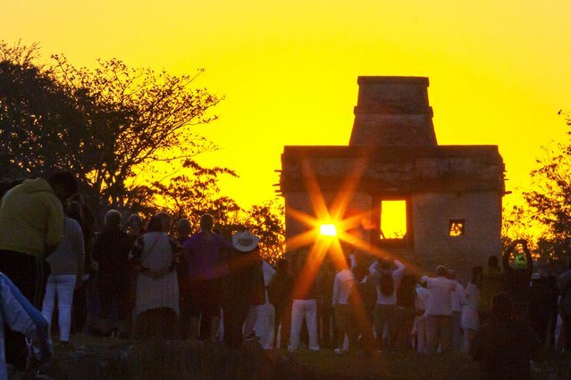 The sun is seen through the door of the Seven Dolls Temple, in the Maya archaeological site of Dzibilchaltun in Yucatan State, Mexico, during the celebration of the spring equinox on March 21, 2023. (Photo by Hugo Borges/AFP Photo)