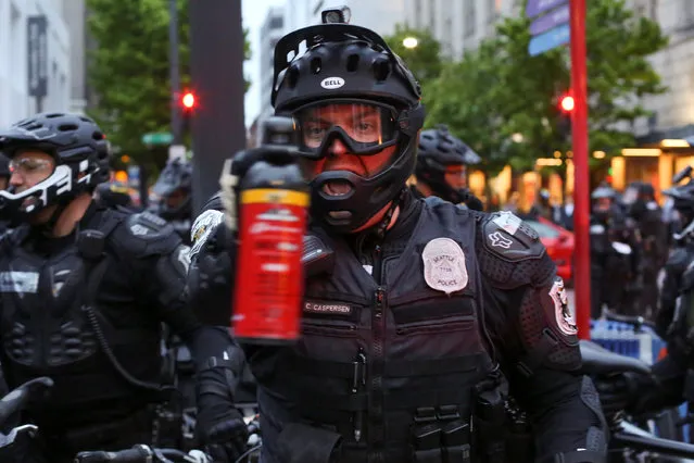 A police officer threatens to use pepper spray during May Day protests in Seattle, Washington, U.S. May 1, 2017. (Photo by David Ryder/Reuters)