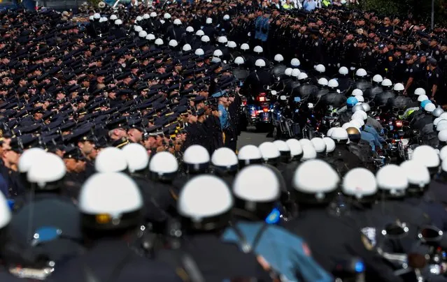 Police motorcycles lead a procession of the casket of shot New York City Police Department officer Brian Mulkeen from his funeral service at the Sacred Heart Church in Monroe, New York, October 4, 2019. Mulkeen, 33, was shot and killed by “friendly fire” on September 29 while investigating gang activity in the Bronx and a suspect also died in the incident, police said. He was the second New York police officer shot dead by colleagues in the line of duty this year. (Photo by Mike Segar/Reuters)