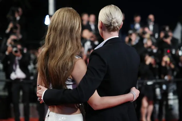 Actresses Charlize Theron and Adele Exarchopoulos embrace each other as they leave “The Last Face” Premiere during the 69th annual Cannes Film Festival at the Palais des Festivals on May 20, 2016 in Cannes, France. (Photo by Andreas Rentz/Getty Images)