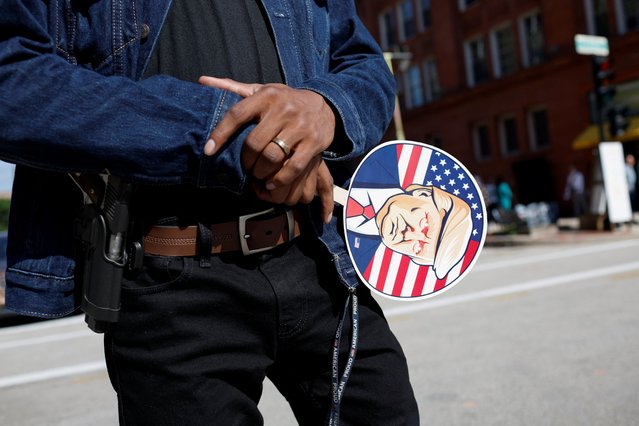 A person holds a sign with an image depicting of former President Donald Trump near the Fiserv Forum on Day 3 of the RNC in Milwaukee, Wisconsin on July 17, 2024. (Photo by Marco Bello/Reuters)