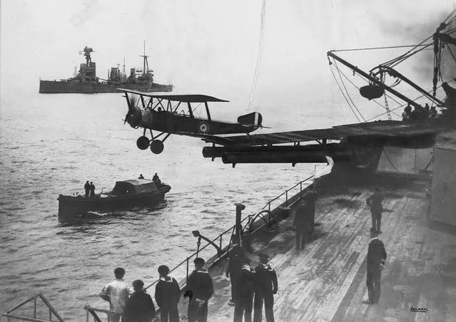 A Sopwith 1 1/2 Strutter biplane aircraft taking off from a platform built on top of HMAS Australia's midships “Q” turret, in 1918. (Photo by State Library of New South Wales via The Atlantic)