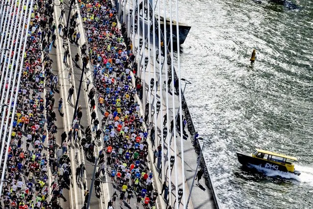 Runners participate in the 41st edition of the Rotterdam Marathon as they cross the Erasmus Bridge in Rotterdam, on April 10, 2022. (Photo by Robin Utrecht/ANP via AFP Photo)