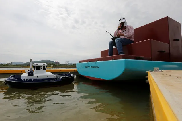 A Panama Canal pilot maneuvers a miniature tugboat as he sits on a scale cargo boat during a training day on the scale model maneuvering training facility of the Panama Canal, on the outskirts of Panama City in Panama June 1, 2016. (Photo by Carlos Jasso/Reuters)