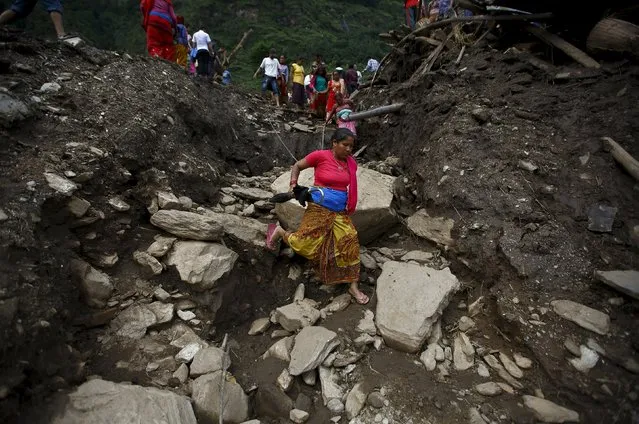 A woman walks along the landslide-affected area at Lumle village in Kaski district July 30, 2015. (Photo by Navesh Chitrakar/Reuters)