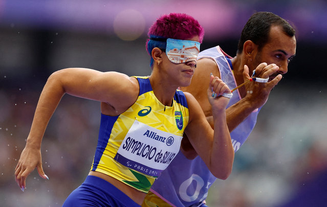 Thalita Vitoria Simplicio da Silva of Brazil with guide Veloso da Silva Felipe in action during heat 3 of the women's 400m T11 round 1 race in Saint-Denis, France on August 30, 2024. (Photo by Stephanie Lecocq/Reuters)