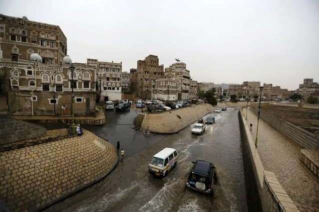 Cars drive in floodwaters during a rainy day in the old quarter of Yemen's capital Sanaa August 1, 2015. (Photo by Khaled Abdullah/Reuters)