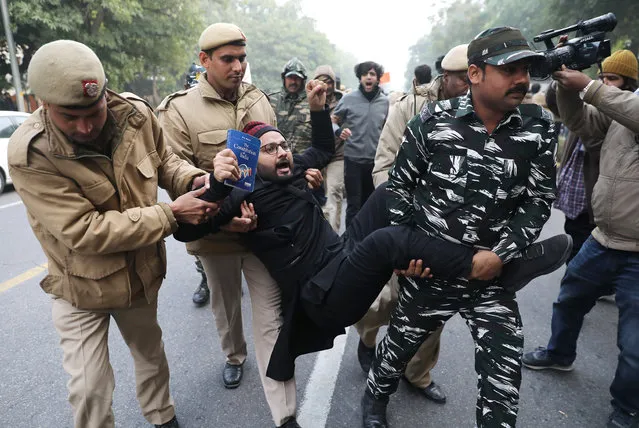 Security personnel detain Indian student activists during a protest against the alleged Police brutality on protesters in Uttar Pradesh state and against the Citizenship Amendment Act (CAA) and National Register of Citizens (NRC), outside Uttar Pradesh Bhawan in New Delhi, India, 27 December 2019. The bill will give Indian citizenship rights to refugees from Hindu, Jain, Buddhist, Sikhs, Parsi or Christian communities coming from Afghanistan, Bangladesh and Pakistan. (Photo by Rajat Gupta/EPA/EFE)