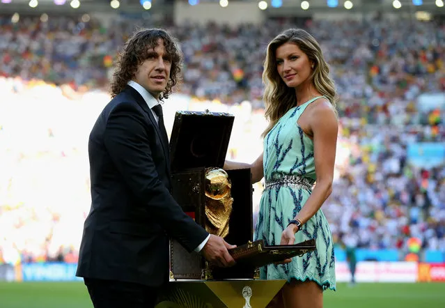 Supermodel Gisele Bundchen and 2010 FIFA World Cup Champion Carlos Puyol  revealing the trophy in a specially cr…