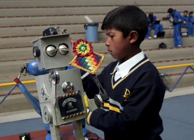 A student from Don Bosco School prepares a robot built with recycled materials during the annual robotics fair supported by the Bolivian Education Ministry in La Paz, August 10, 2015. (Photo by David Mercado/Reuters)