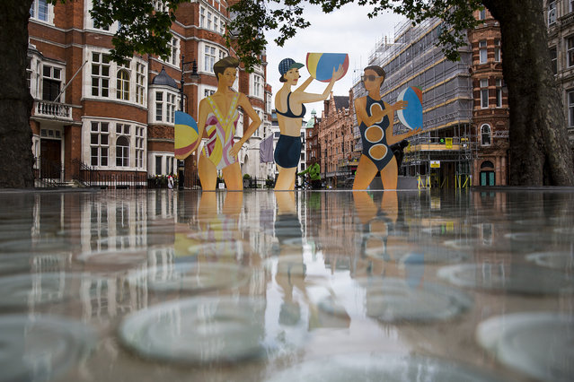 A cutout sculpture of three female bathers titled “Chance” by Alex Katz in Mayfair on June 21, 2016 in London, England. The work by the American artist will remain in place just for today before being moved to the Timothy Taylor gallery in Mayfair to mark the “Alex Katz: Quick Light” exhibition at the Serpentine Gallery, which runs till September. (Photo by Jack Taylor/Getty Images)