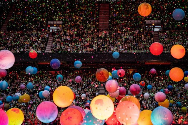 Fans cheer as British singer Chris Martin of British band Coldplay performs at Parken Stadium in Copenhagen, on July 5, 2023. The concert is part of the Music of the Spheres World Tour. (Photo by Mads Claus Rasmussen/Ritzau Scanpix via AFP Photo)