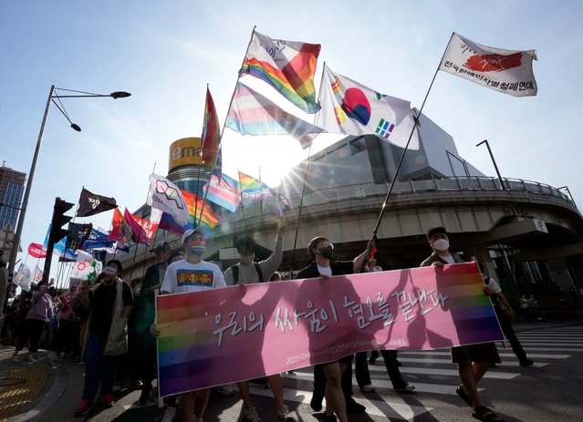 LGBT rights supporters march toward the new presidential office during a rally demanding the government to immediately pass anti-discrimination laws in Seoul, South Korea, Saturday, May 14, 2022. (Photo by hn Young-joon/AP Photo)