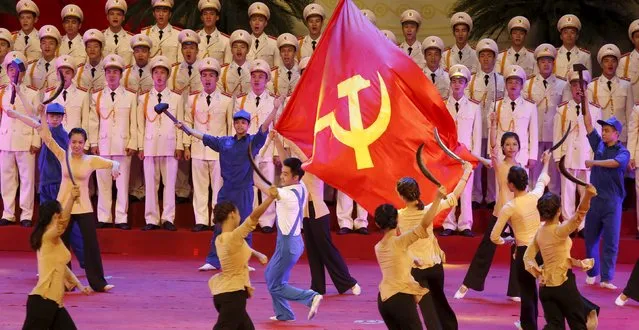 A man waves a communist flag during celebrations to commemorate the 70th anniversary of the establishment of the Vietnam Public Security police force at the National Convention Center in Hanoi August 18, 2015. (Photo by Reuters/Kham)