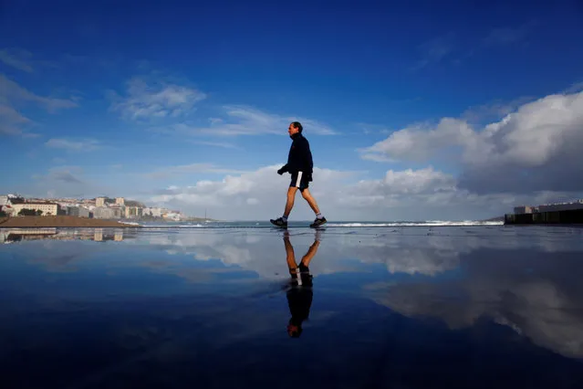 A man walks along the promenade in A Coruna, Spain, 17 February 2020. According to forecasts, rain is expected throughout the no​rth-east of the country. (Photo by Cabalar/EPA/EFE)