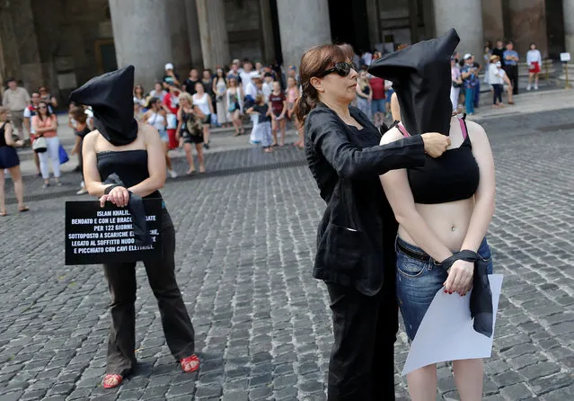 Amnesty International activists take part in a performance to protest against enforced disappearance in downtown Rome, Italy July 13, 2016. A report from Amnesty International has turned the focus on alleged kidnapping and torture in Egypt of hundreds of students, political activists, protesters and even young teenagers during the past three years. A demonstration in Rome organised by the charity sought to highlight how people vanished without trace after security forces raided their homes. Most of them, it is claimed are supporters of former Muslim Brotherhood president Mohamed Morsi. (Photo by Tony Gentile/Reuters)