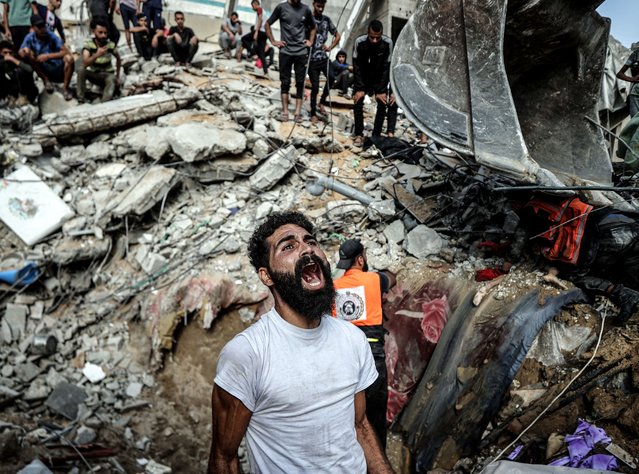 A Palestinian man mourns as civil defense teams and residents conduct a search and rescue operation for Palestinians stuck under the debris of a demolished building following Israeli airstrikes hit Al-Shati refugee camp in Gaza City, Gaza on October 24, 2023. (Photo by Ali Jadallah/Anadolu via Getty Images)