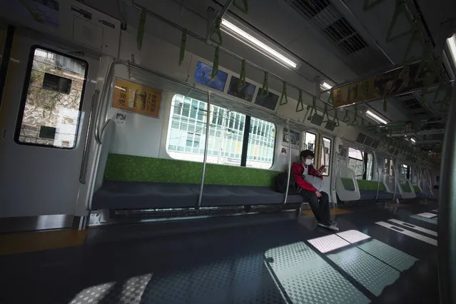 A man with protective mask rides an empty train Wednesday, April 8, 2020, in Tokyo. Japanese Prime Minister Shinzo Abe declared a state of emergency yesterday for Tokyo and six other prefectures to ramp up defenses against the spread of the coronavirus. (Photo by Eugene Hoshiko/AP Photo)