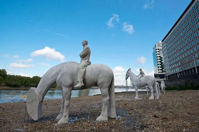 “The Rising Tide” by British underwater sculptor Jason deCaires Taylor is installed on the bank of the River Thames, September 2, 2015 in London. (Photo by Ben Pruchnie/Getty Images)
