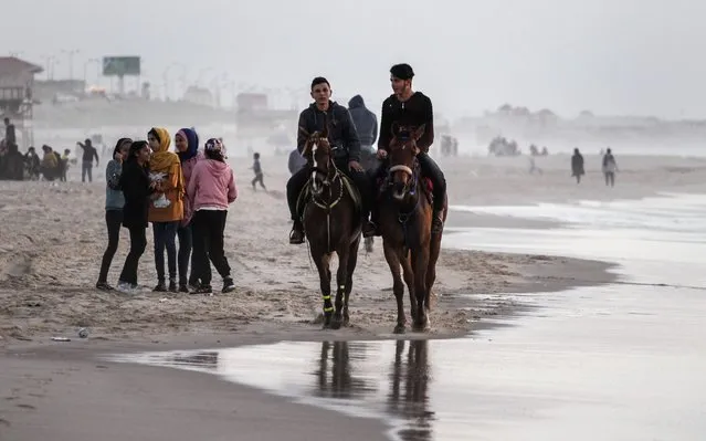 Palestinians enjoy a sunny day at the beach of Gaza City, on March 29, 2020. (Photo by Sameh Rahmi/NurPhoto via Getty Images)