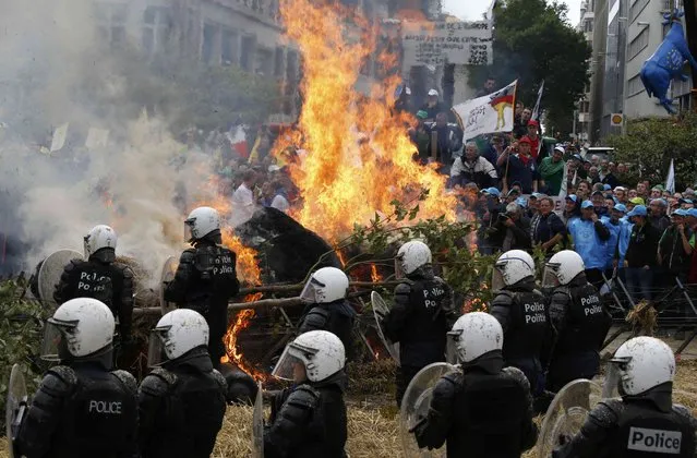 Belgian riot police officers clash with protesters as farmers and dairy farmers from all over Europe take part in a demonstration outside an European Union farm ministers emergency meeting at the EU Council headquarters in Brussels, Belgium, September 7, 2015. (Photo by Jacky Naegelen/Reuters)