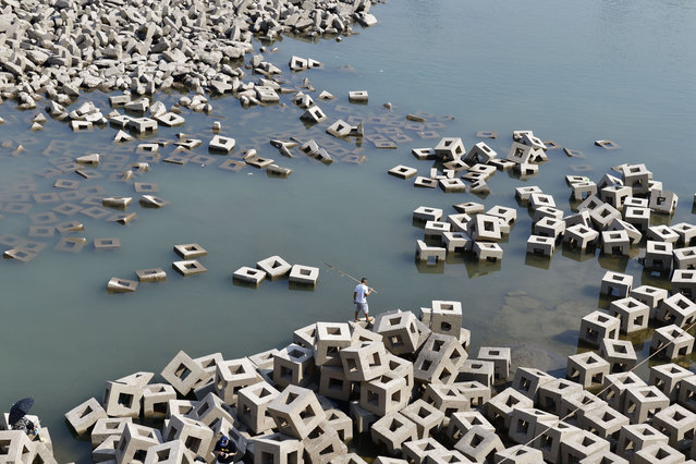 Stone pillars are exposed in the Yangtze River on September 14, 2022 in Chongqing, China. The water level of Yangtze River has dropped due to sustained high temperatures and little rain. (Photo by VCG/VCG via Getty Images)