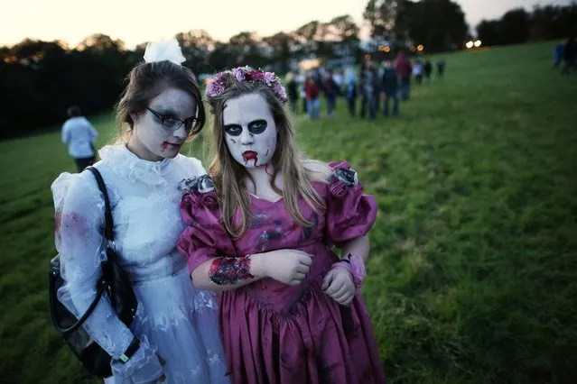 Visitors to the Shocktober Fest dressed as zombies pose at Tulleys Farm  on October 6, 2012 in Turners Hill, England. People dressed as zombies from around the United Kingdom have converged on Tulleys Farm in an attempt to set a new Guinness World Record for the most zombies together in one place.  (Photo by Peter Macdiarmid)