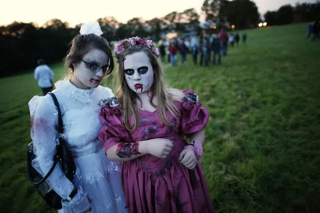 Visitors to the Shocktober Fest dressed as zombies pose at Tulleys Farm on October 6, 2012 in Turners Hill, England. People dressed as zombies from around the United Kingdom have converged on Tulleys Farm in an attempt to set a new Guinness World Record for the most zombies together in one place. (Photo by Peter Macdiarmid)