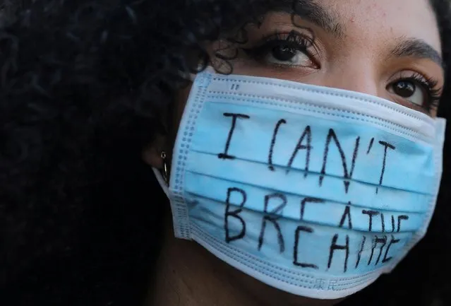 A woman wearing a face mask with the words “I can't breathe” looks on during a protest against the death in Minneapolis police custody of George Floyd, in front of a U.S. consulate in Barcelona, Spain on June 1, 2020. (Photo by Nacho Doce/Reuters)