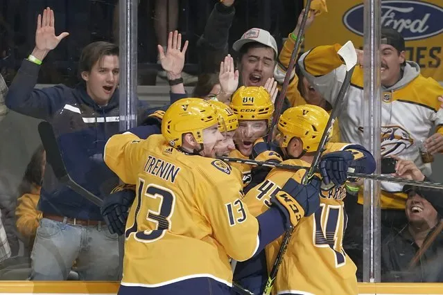 Fans and players celebrate after a goal by Nashville Predators' Tanner Jeannot (84) in the second period of an NHL hockey game against the Los Angeles Kings Tuesday, October 18, 2022, in Nashville, Tenn. (Photo by Mark Humphrey/AP Photo)