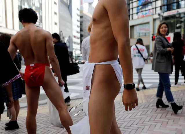 Participants wearing the traditional “fundoshi” or loin cloth attend an event to pick trash on the streets in Tokyo, Japan, October 5, 2017. This event was organized in an effort to promote the wearing of this traditional garb and the participants can explore self-expression and gain self-confidence by picking up garbage while wearing fundoshi. (Photo by Kim Kyung-Hoon/Reuters)