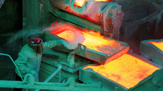 A worker monitors a process inside the plant at the copper refinery of Codelco Ventanas in Ventanas city, northwest of Santiago, Chile January 7,  2015. (Photo by Rodrigo Garrido/Reuters)