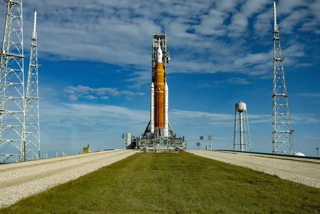The Artemis I unmanned lunar rocket sits on launch pad 39B at NASA's Kennedy Space Center in Cape Canaveral, Florida, on November 13, 2022. NASA said on November 11 it plans to attempt its long-delayed uncrewed mission to the Moon as scheduled November 16, after inspections revealed only minor damage from Hurricane Nicole's passage through Florida. (Photo by Jim Watson/AFP Photo)