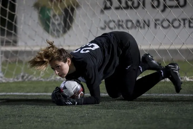 Joud Shunti, 23-year-old goalkeeper, works out during a training of the Orthodox Club's women's team in Amman, Jordan, Saturday, October 22, 2022. Women's soccer has been long been neglected in the Middle East, a region that is mad for the men's game and hosts the World Cup for the first time this month in Qatar. (Photo by Raad AL-Adayleh/AP Photo)