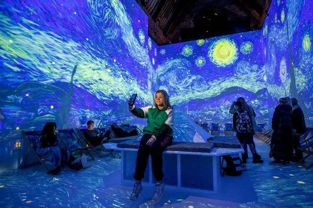 Evvie Bishop looks at Van Gogh's, The Starry Night, is displayed at Van Gogh: The Immersive Experience exhibition at Carlisle Memorial Church in Belfast on Monday, November 28, 2022. (Photo by Liam McBurney/PA Images via Getty Images)
