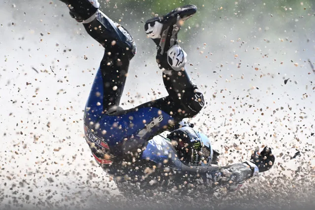 Monster Energy Yamaha's Spanish rider Maverick Vinales rolls on the ground after he crashed during the first training session ahead of the Moto GP Czech Grand Prix at Masaryk's circuit in Brno on August 7, 2020. (Photo by  Joe Klamar/AFP Photo)