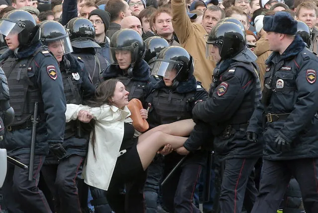 Russian riot policemen detain a demonstrator during an opposition rally in central Moscow, Russia, 26 March 2017. Russian opposition leader Alexei Navalny called on his supporters to join a demonstration in central Moscow despite a ban from Moscow authorities. Throughout Russia the opposition held the so-called anti-corruption rallies. According to reports, dozens of demonstrators have been detained across the country as they called for the resignation of Russian Prime Minister Dmitry Medvedev over corruption allegations. (Photo by Maxim Shipenkov/EPA/EFE)